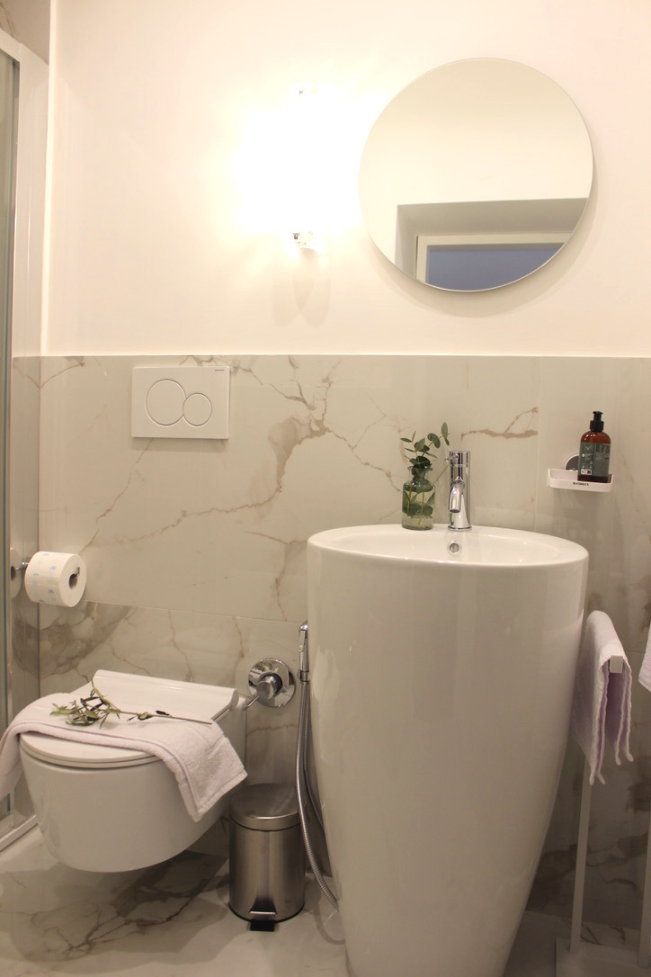 Ensuite 1 bathroom with marble tiles and pedestal sink