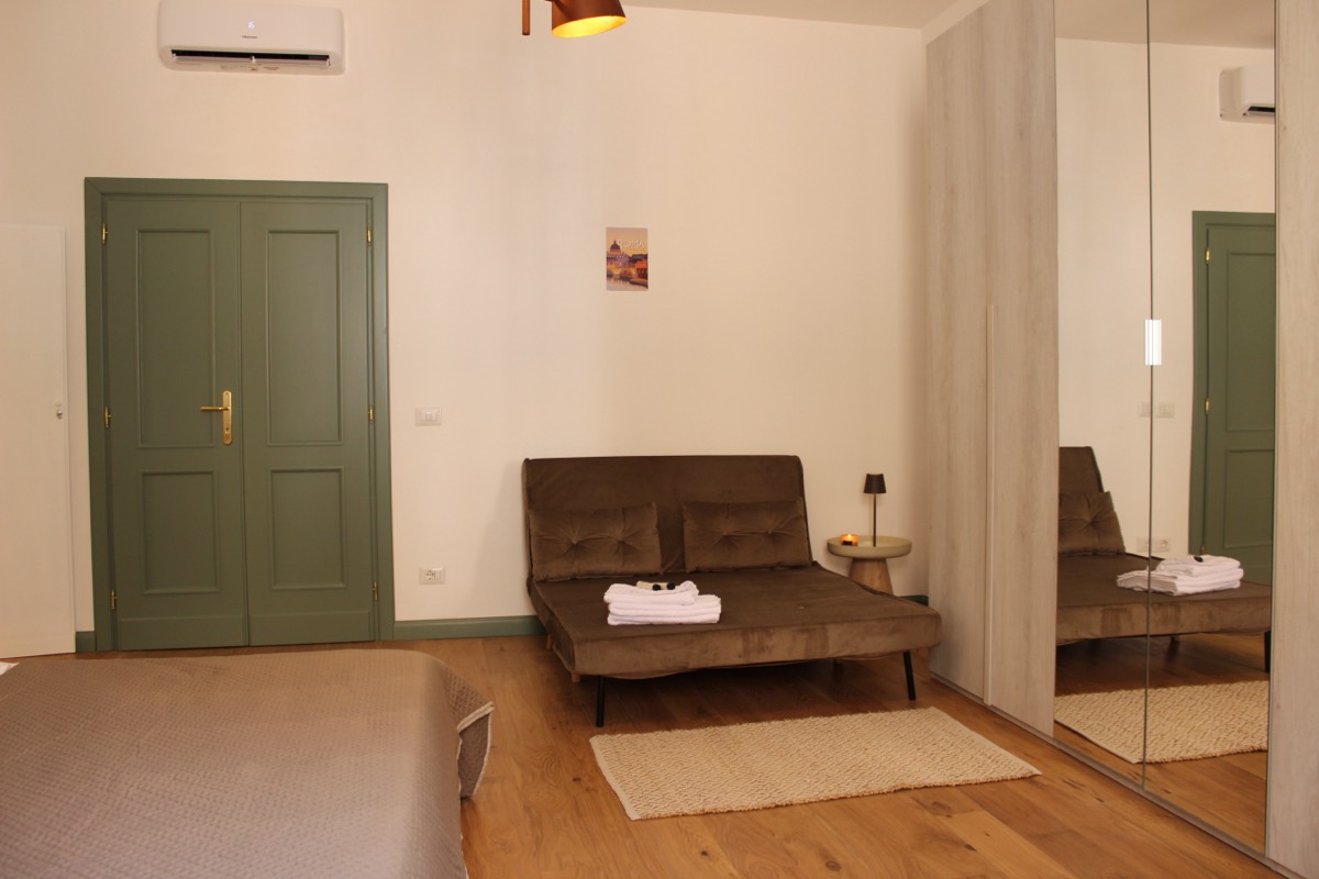 Pull-out sofa bed and wardrobe in a bedroom