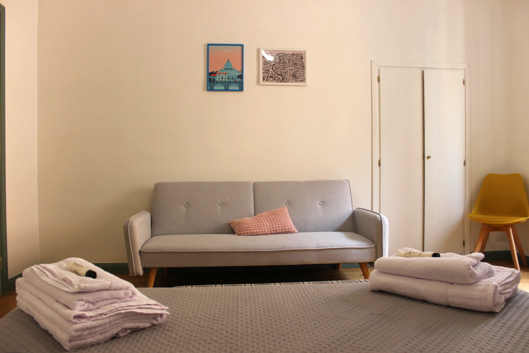 Gray pull-out sofa bed in a bedroom